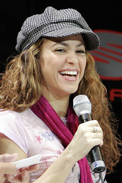 Colombian singer Shakira laughs while attending a promotional event at the booth of the car manufacturer Seat during the 2nd media day of the 77th...