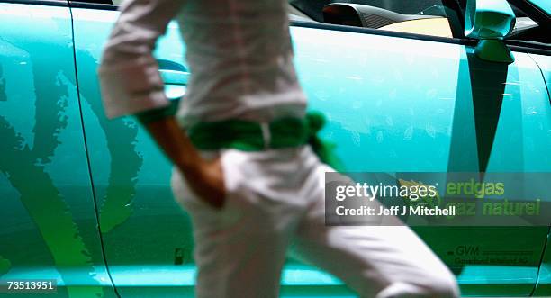 Models stand next to a Opel Corsa running on gas at the 77th International Motor Show, March 7, 2007 in Geneva, Switzerland. The first major car show...