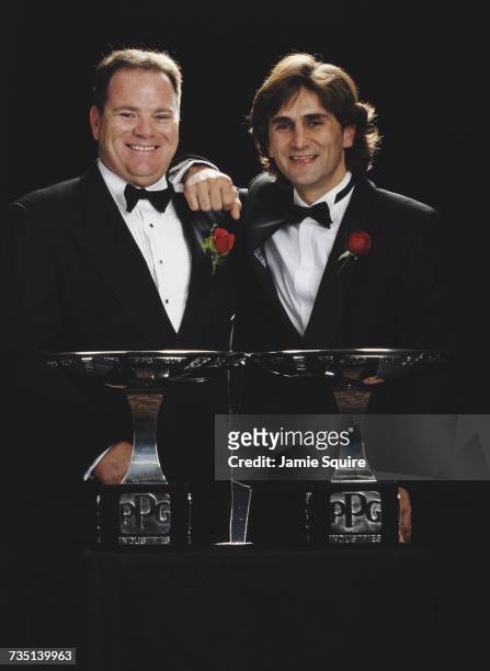 Alex Zanardi of Italy , driver of the Target Ganassi Racing Reynard 98i Honda stands with team owner Chip Ganassi and the Drivers' Champion Trophy...