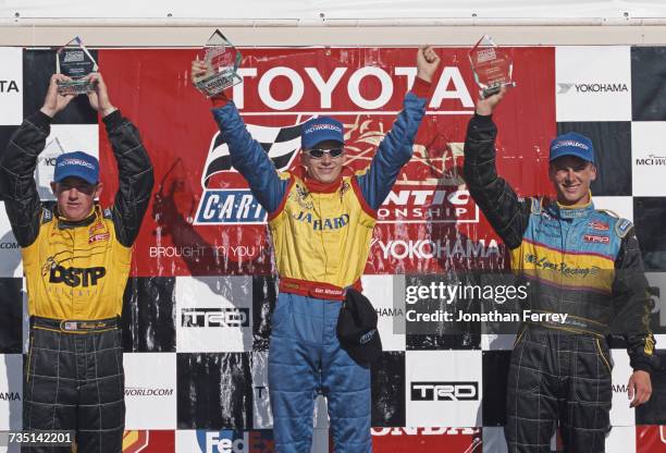 Dan Wheldon of Great Britain driver of the PPI Motorsports Swift 011c Toyota celebrates with second placed David Rutledge and third placed Buddy Rice...