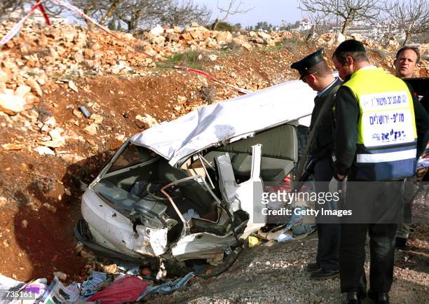 Israeli police inspect the remains of the van of Benjamin Kahane, the son of the assassinated right-wing extremist Rabbi Meir Kahane, who was shot...