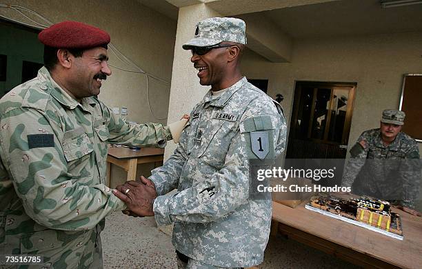 Newly-promoted U.S. Army Sergeant Major John Yarborough , of the 1st Infantry Division, is congratulated by a sergeant in the Iraqi Army after a...