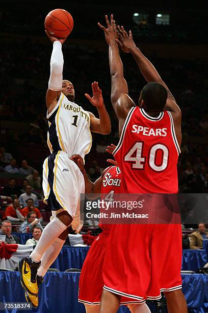 Aaron Spears of the St. Johns Red Storm defends against Dominic James of the Marquette Golden Eagles during the first round of the Big East...