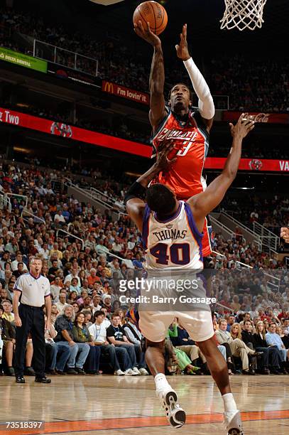 Gerald Wallace of the Charlotte Bobcats shoots over Kurt Thomas of the Phoenix Suns on March 7, 2007 at U.S. Airways Center in Phoenix, Arizona. NOTE...