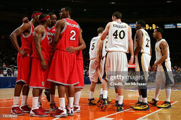 The St. Johns Red Storm and the Marquette Golden Eagles huddle up during the first round of the Big East Championship at Madison Square Garden On...