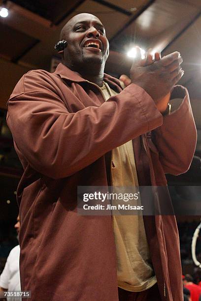 Former New York Knick Anthony Mason watches as his son Anthony Mason Jr. #2 of the St. Johns Red Storm takes on the Marquette Golden Eagles during...