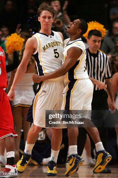 Dan Fitzgerald and David Cubillan of the Marquette Golden Eagles celebrate a basket against the St. Johns Red Storm during the first round of the Big...