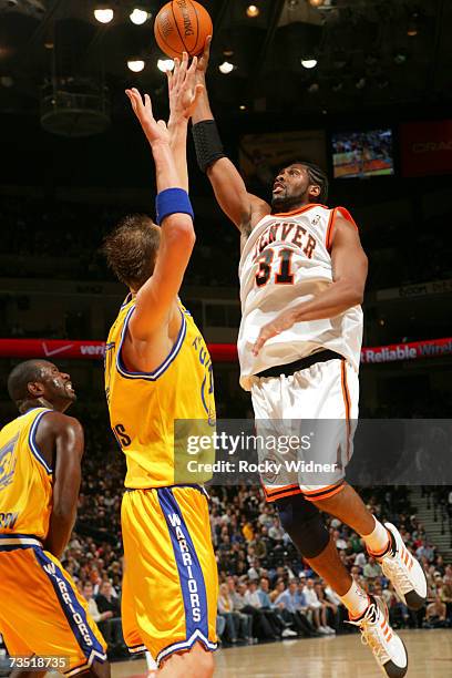 Nene of the Denver Nuggets goes up for the shot against Andris Biedrins of the Golden State Warriors at Oracle Arena March 7, 2007 in Oakland,...