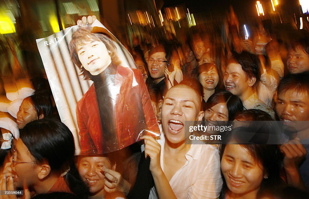 Vietnamese fans cheer up with a posters...