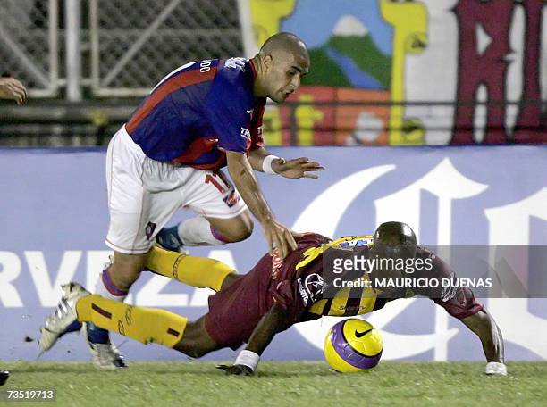 Ernesto Cristaldo of Cerro Porteno from Paraguay fights for the ball with Roger Cambindo of Colombia's Deportes Tolima during their Copa Libertadores...