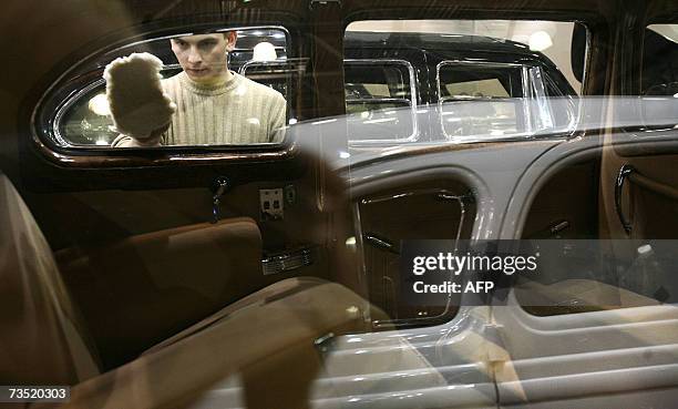 Moscow, RUSSIAN FEDERATION: A man as he cleanes a window of ZIS-110 limousine used by Josef Stalin from a special purpose garage of FSB before the...