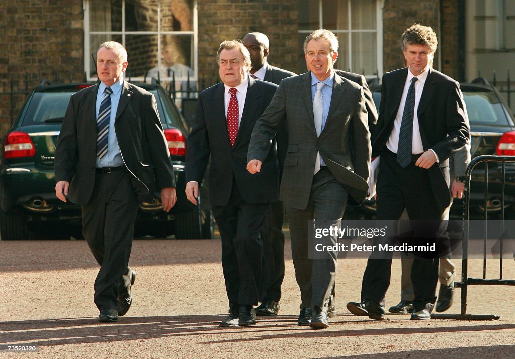 Security officers surround Prime Minister Tony Blair as he walks to a