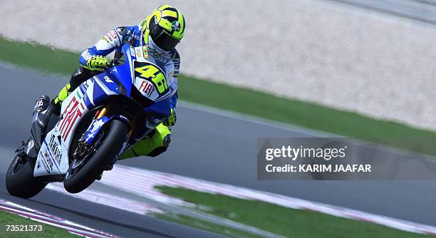 Italian rider and world champion Valentino Rossi of Yamaha pulls a wheelie a during free practice at the Losail International Circuit on the...