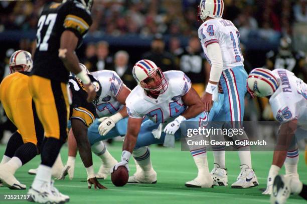 Offensive lineman Bruce Matthews of the Houston Oilers looks up before snapping the ball to quarterback Cody Carlson during a game against the...