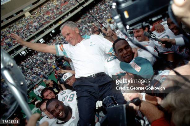 Head coach Don Shula of the Miami Dolphins is carried off the field by Dolphins players after recording his 325th career victory, a 19-14 win over...