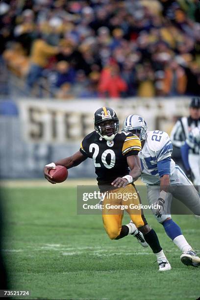 Defensive back Dewayne Washington of the Pittsburgh Steelers runs from running back Lamont Warren of the Detroit Lions after intercepting a pass...