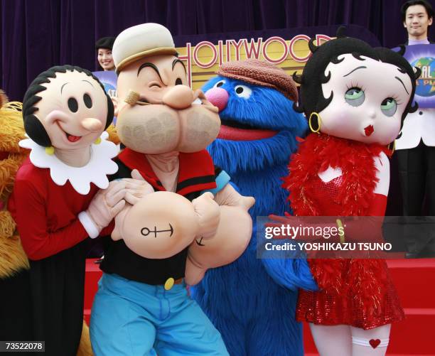 Cartoon movie characters Olive, Popeye, Sesame Street's Grover and Betty Boop pose during the launch of the new roller coaster "Hollywood Dream the...