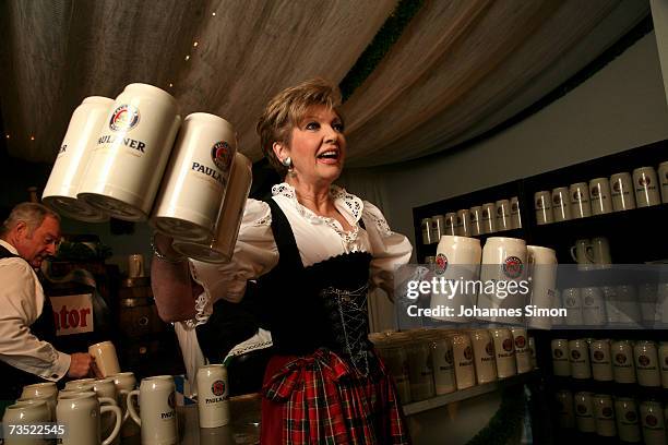 Presenter Caroline Reiber poses with beer tankards at the Nockherberg beer hall as the Strong Beer Season kicks off on March 8 in Munich, Germany....