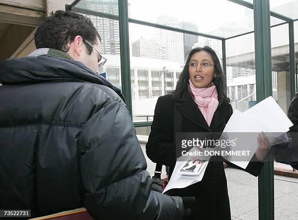 New York, UNITED STATES: TO GO WITH AFP STORY - Presidentielle-France-USA Corinne Narassiguin hands out fliers showing support of the French...