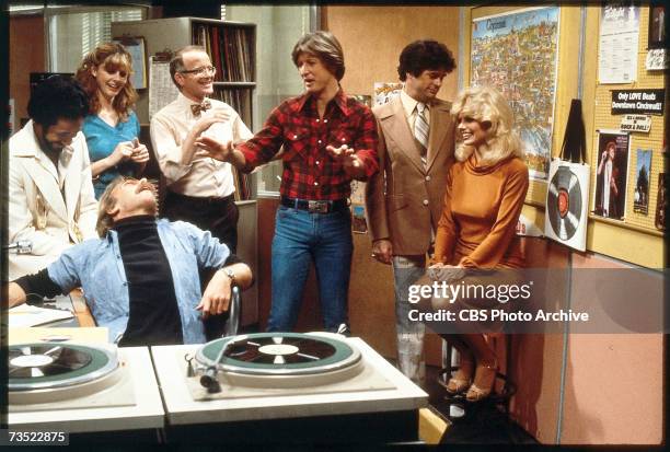 The cast of the television comedy 'WKRP in Cincinnati' share a laugh in the studio in a still from an unidentified episode, Los Angeles, Calfornia,...