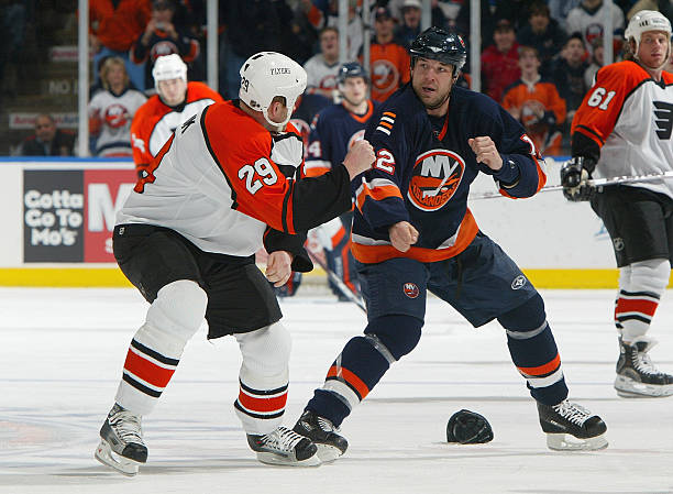 Chris Simon of the New York Islanders fights against Todd Fedoruk of the Philadelphia Flyers during their NHL game on February 27, 2007 at Nassau...