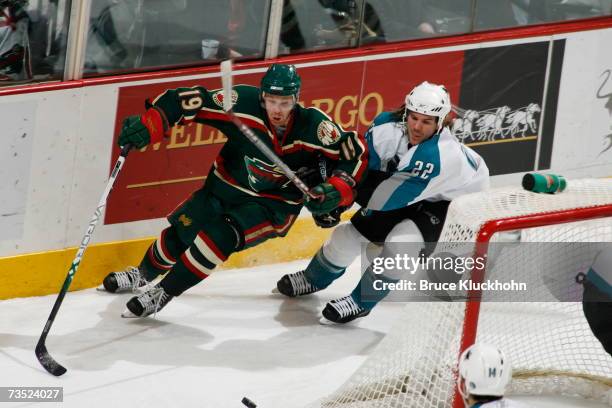 Stephane Veilleux of the Minnesota Wild skates against Scott Hannan of the San Jose Sharks during the game at Xcel Energy Center on March 6, 2007 in...