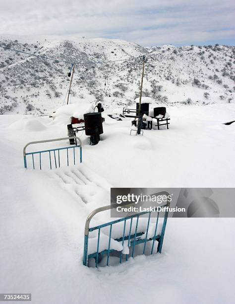 Snow covers an old bed in one of the primitive camps inhabited by Kyrgyz labourers close to the ruins of an old Soviet elctrolamp factory, where they...