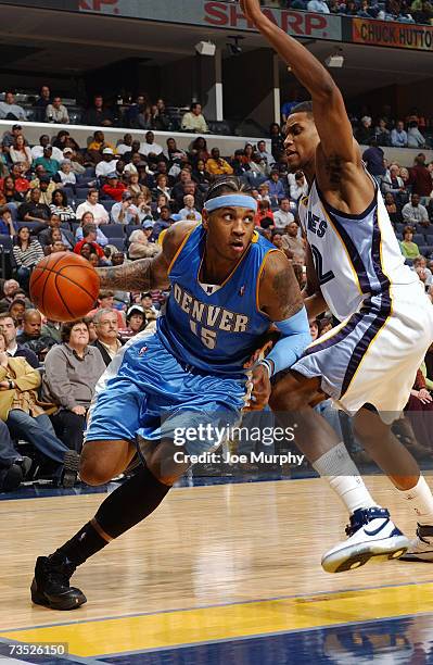 Carmelo Anthony of the Denver Nuggets drives baseline around Rudy Gay of the Memphis Grizzlies during the game at FedExForum on February 26, 2007 in...