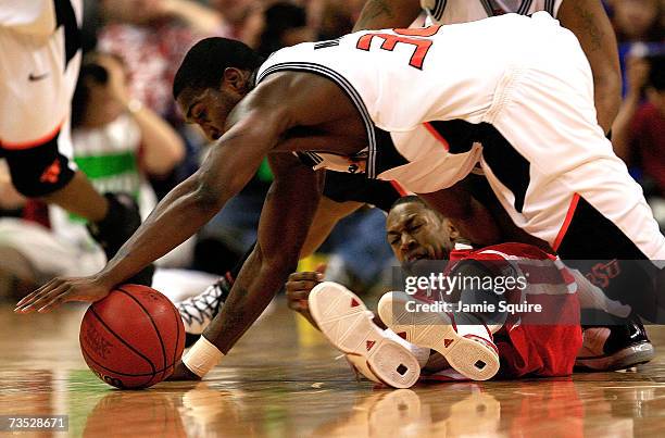 David Monds of the Oklahoma State Cowboys battles Charles Richardson of the Nebraska Cornhuskers for the ball during the first round of the Phillips...