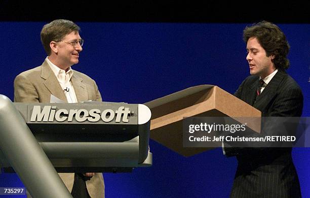 Bill Gates, left, Chairman and Chief Software Architect of Microsoft, is given a new sweater by David Lauren, Chief Creative Officer and Vice...