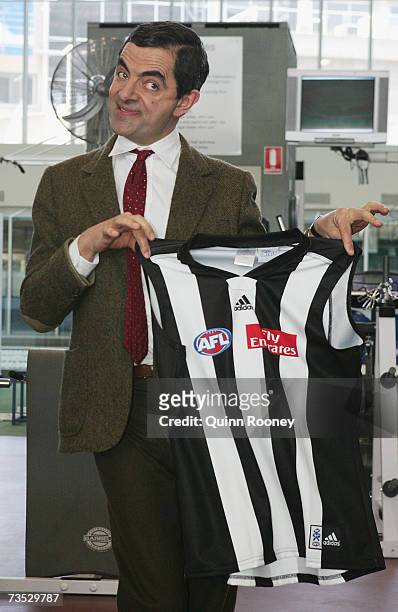 Actor Rowan Atkinson in character as Mr. Bean shows his delight after being presented with a Collingwood Magpies guernsey by Nathan Buckley of the...