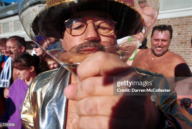 Street Brownie member Chico Malkofsky takes a drink of champagne January 1, 2001 prior to his annual New Year's day swim in Boston Harbor in Boston,...