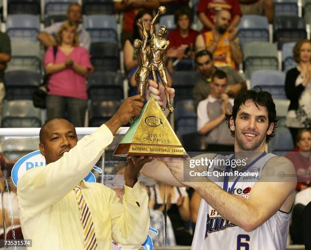 Joey Wright the coach and Sam MacKinnon the captain of the Bullets raise the trophy after winning game four of the NBL Grand Final Series between the...