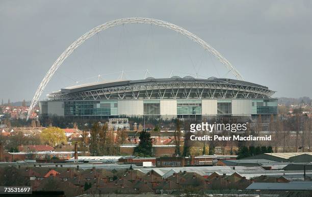 The nearly complete Wembley Stadium rises above local buildings on March 9, 2007 in London. The Football Association is expected to receive the keys...