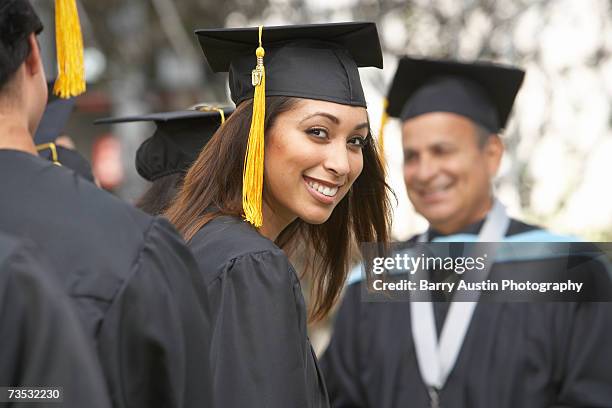 female graduate student at graduation ceremony, portrait - graduation hat stock-fotos und bilder