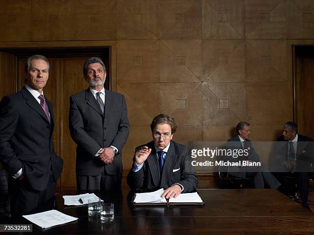 mature men at end of table in conference room, portrait - politician stock-fotos und bilder
