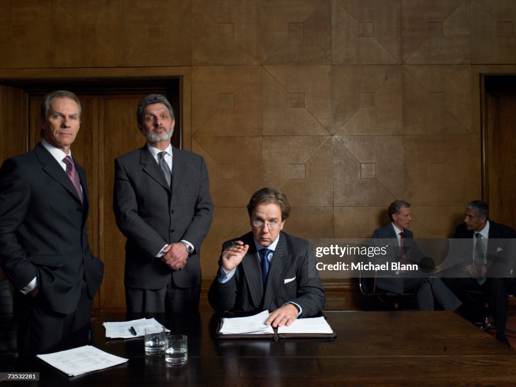 Mature men at end of table in conference room, portrait