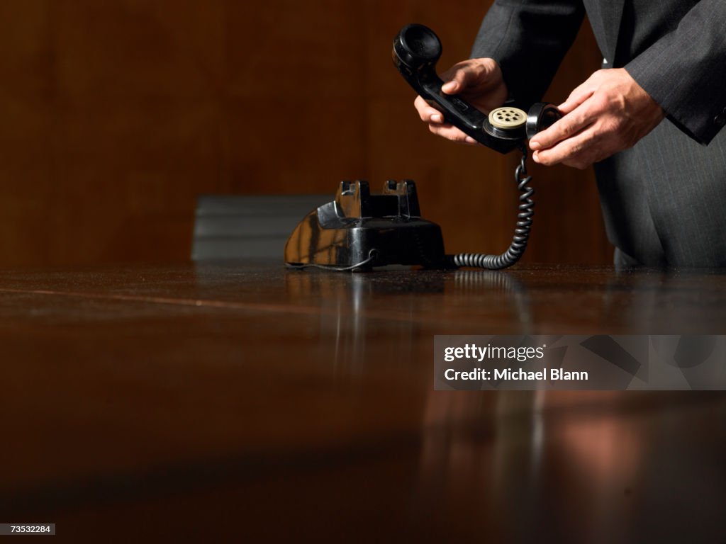 Mature man holding dismantled phone