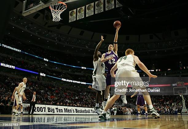 Ivan Tolic of the Northwestern Wildcats attempts a shot against Marquise Gray and Drew Naymick of the Michigan State Spartans during Day 1 of the Big...