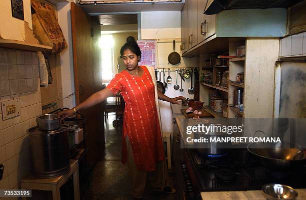 In this photograph dated 22 May 2006, domestic worker and author Baby Halder works in the kitchen of her employer Professor Prabodh Kumar in Gurgaon,...