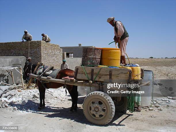 Water is hauled by mule to a construction site of a school erected by German relief organization Agro Action, or, in German, Welthungerhilfe on...