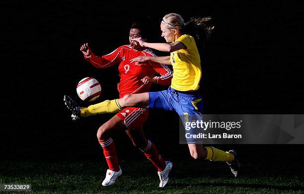 Huan Duan of China in action with Stina Segerstroem of Sweden during the Algarve Cup match between Sweden and China on March 9, 2007 in Faro,...