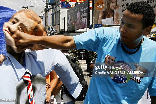 Protester gives a thump to a dummy which represents US President George W. Bush near the Hilton Hotel in Sao Paulo, 09 March 2007. Bush left Thursday...