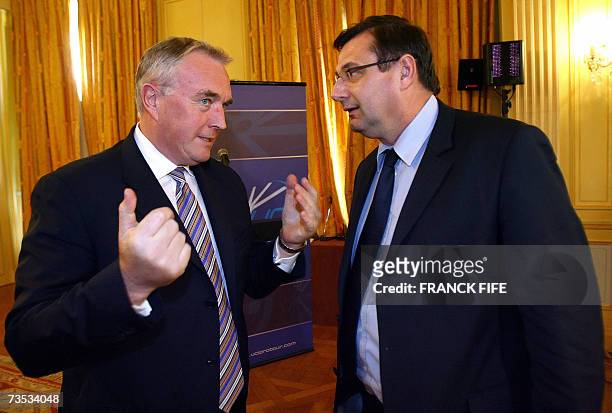 French Sports minister and vice-president of the World Anti-Doping Agency Jean-Francois Lamour speaks with International Cycling Union president Pat...