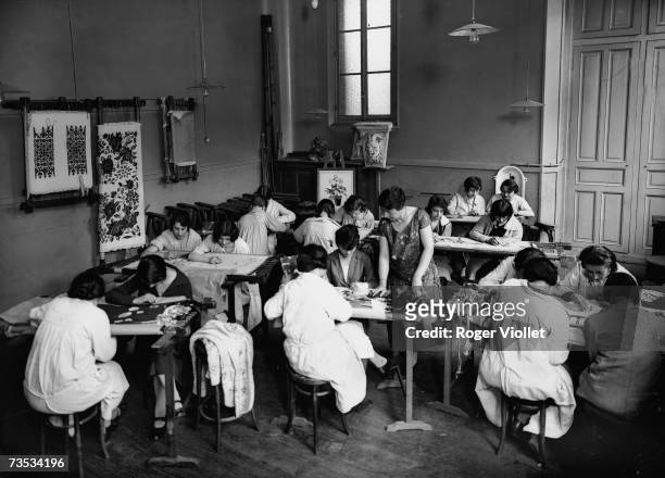 An Art school in Paris, about 1925. Having an embroidery lesson in Paris, France.
