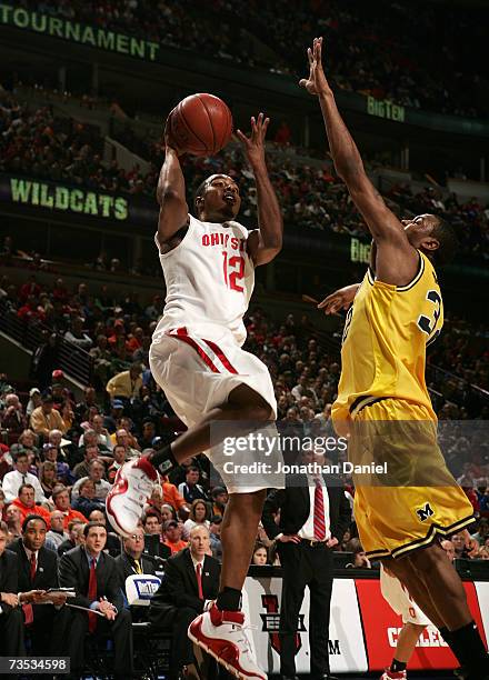 Ron Lewis of the Ohio State Buckeyes drives for a shot attempt against Lester Abram of the Michigan Wolverines during the quarterfinals of the Big...