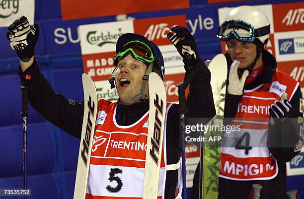 Canadian Pierre Alexandre Rousseau celebrates in front of US Nathan Roberts in the finish area of the Men's Moguls race of the Freestyle World...