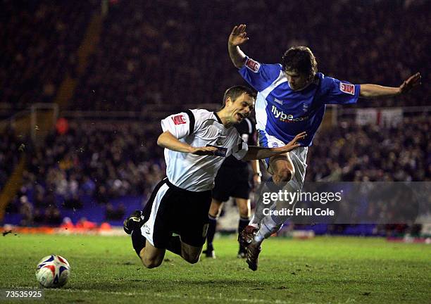 Morten Bisgaard of Derby County goes down against Mat Sadler of Birmingham City during the Coca-Cola Championship match between Birmingham City and...