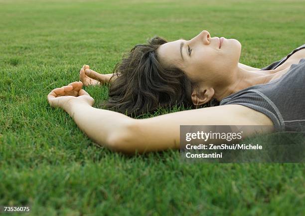 woman lying in grass - at a glance ストックフォトと画像