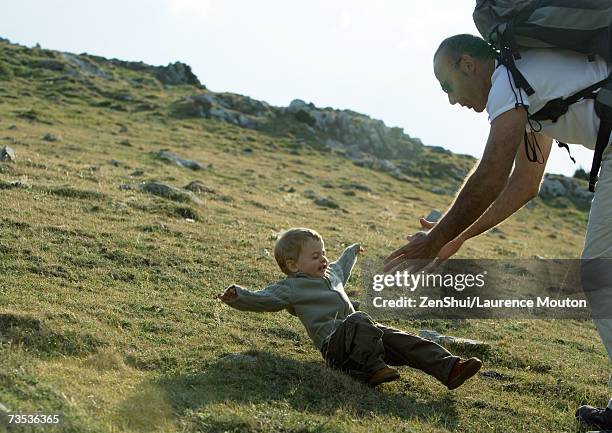 boy falling as father reaches for him - kid looking down stock pictures, royalty-free photos & images